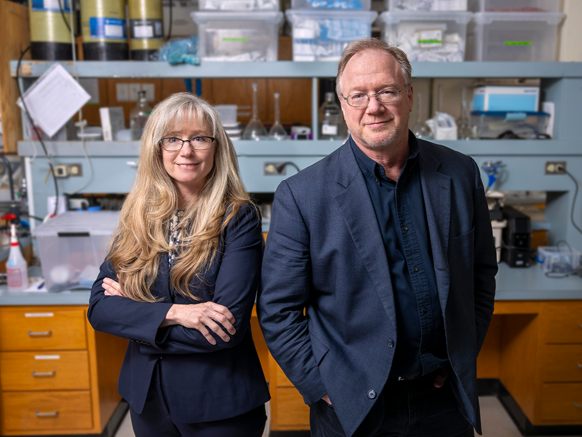 woman and man stand side-by-side in research lab