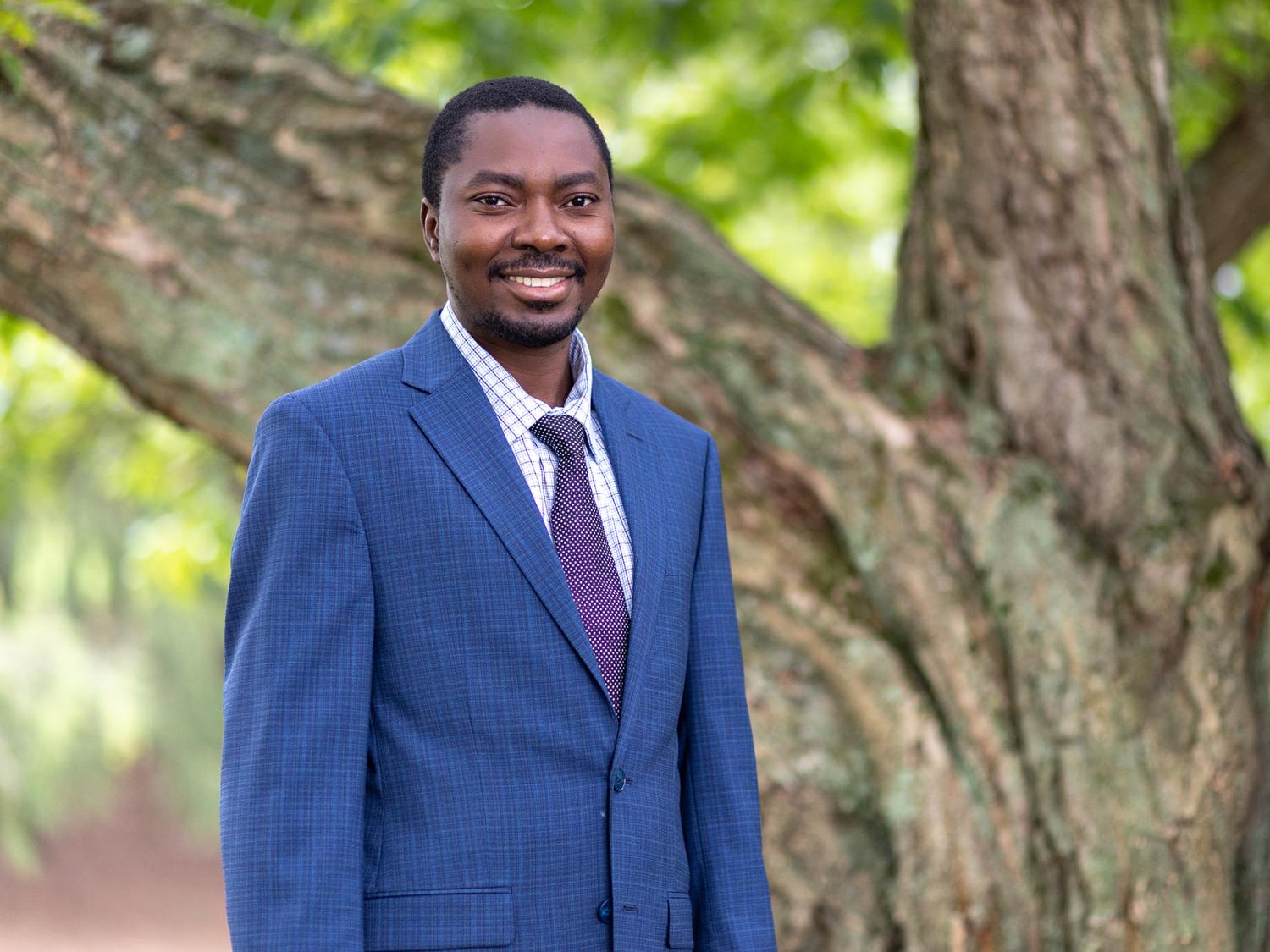 A person wearing a shirt, tie and blue suit jacket. 