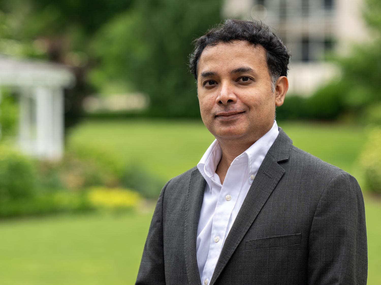 portrait of a person in a suit jacket standing outside