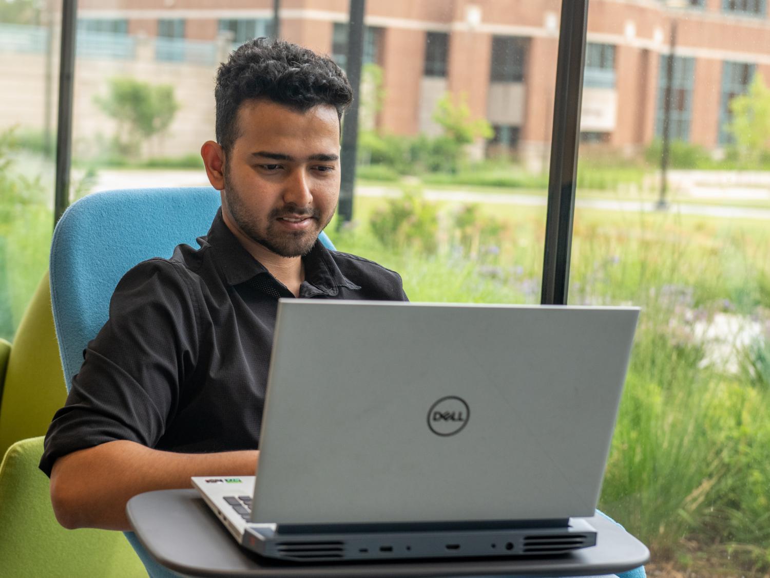 A student working at a laptop computer.  