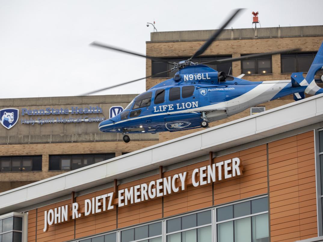 A helicopter lifts off from the roof of a building labeled "John R. Dietz Emergency Center."