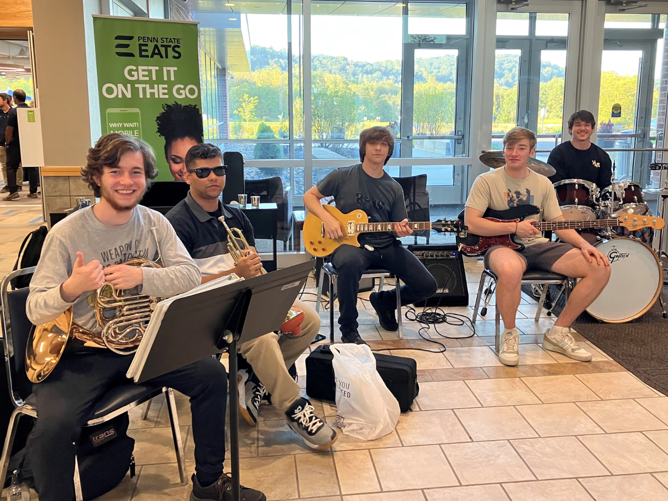 a group of male students playing instruments 