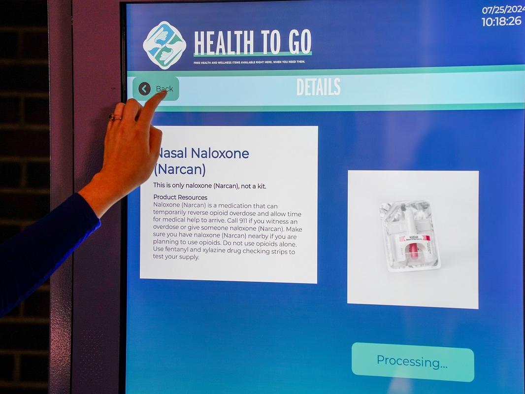 Photo shows the touch screen of an interactive vending machine that dispenses health care items