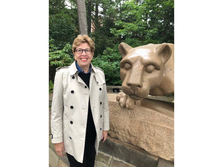 Nancy Arnold stands next to the Nittany Lion Shrine.