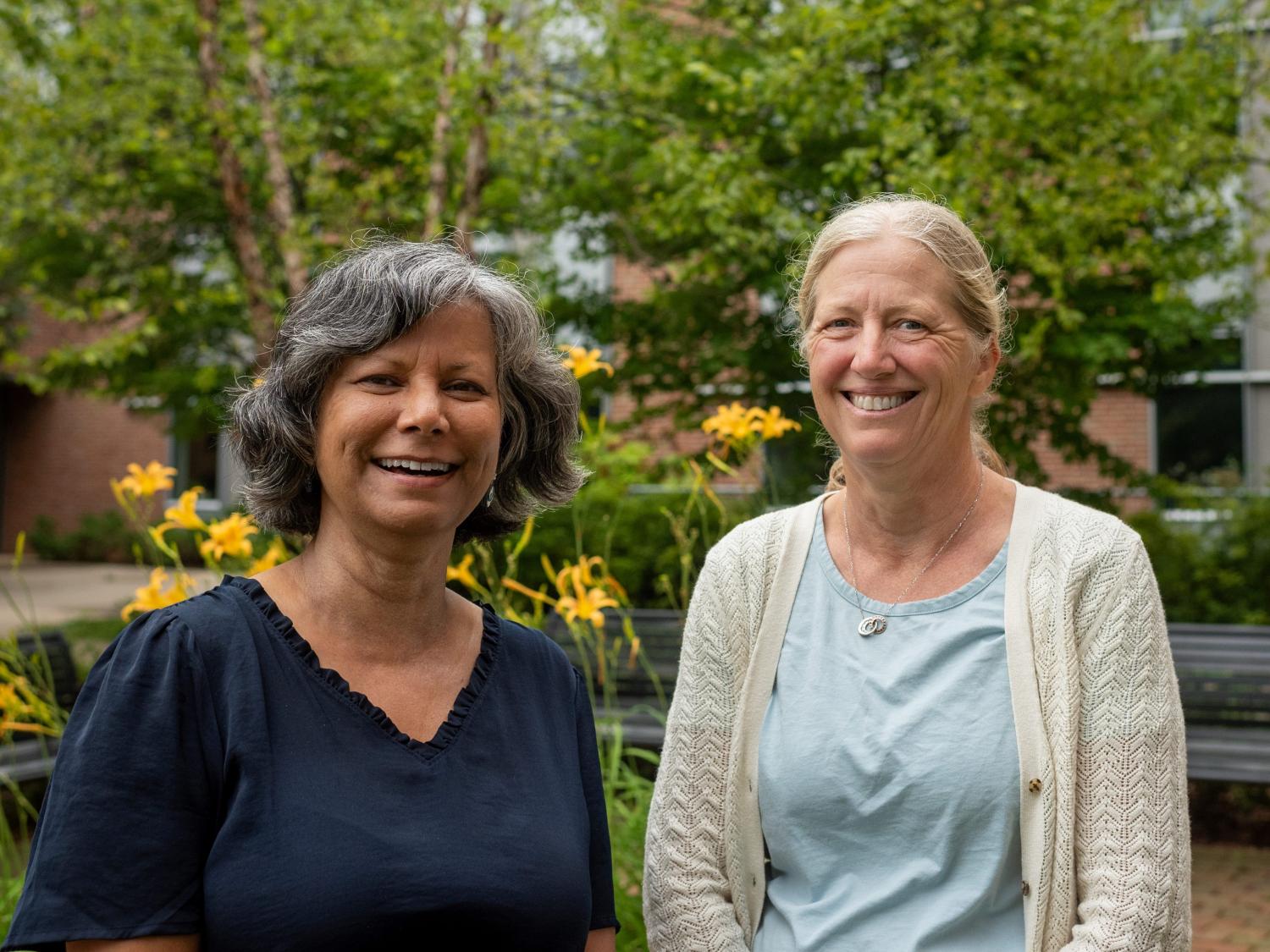 Photo of Rina Eiden and Jenae Neiderhiser standing outdoors 