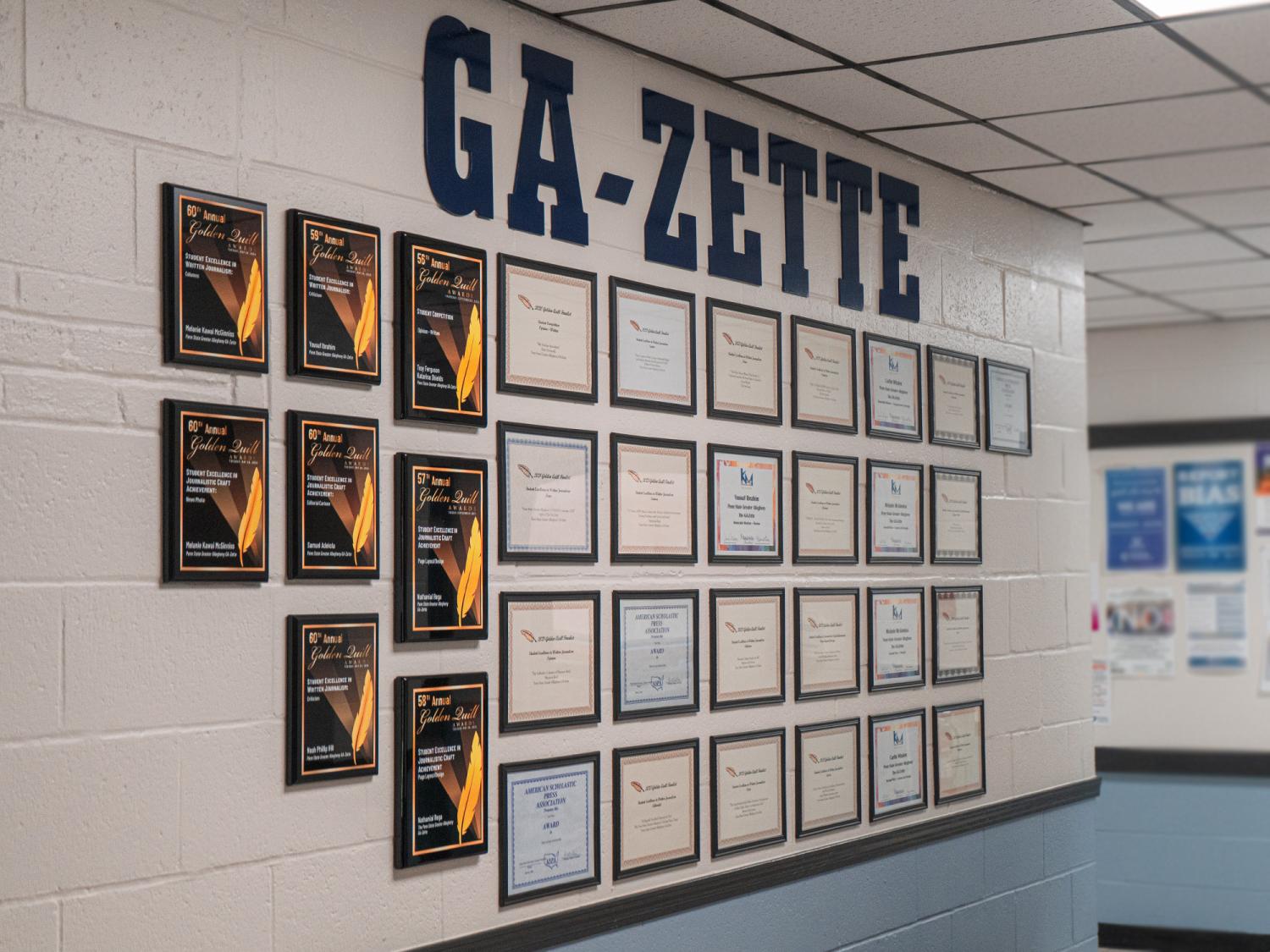 Interior building wall displaying framed awards
