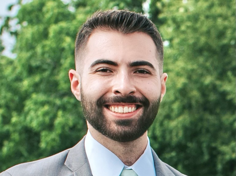 Portrait of Nicholas Palermo wearing a gray suit.