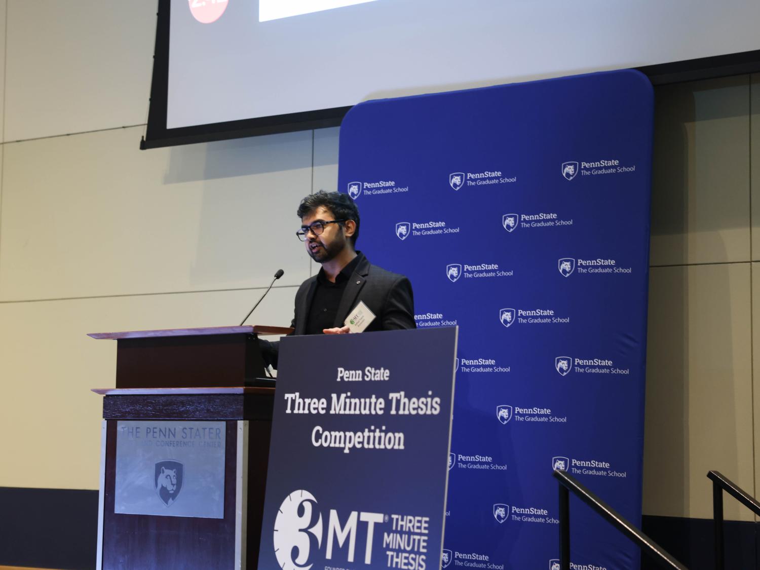 A person talks at a podium for an event