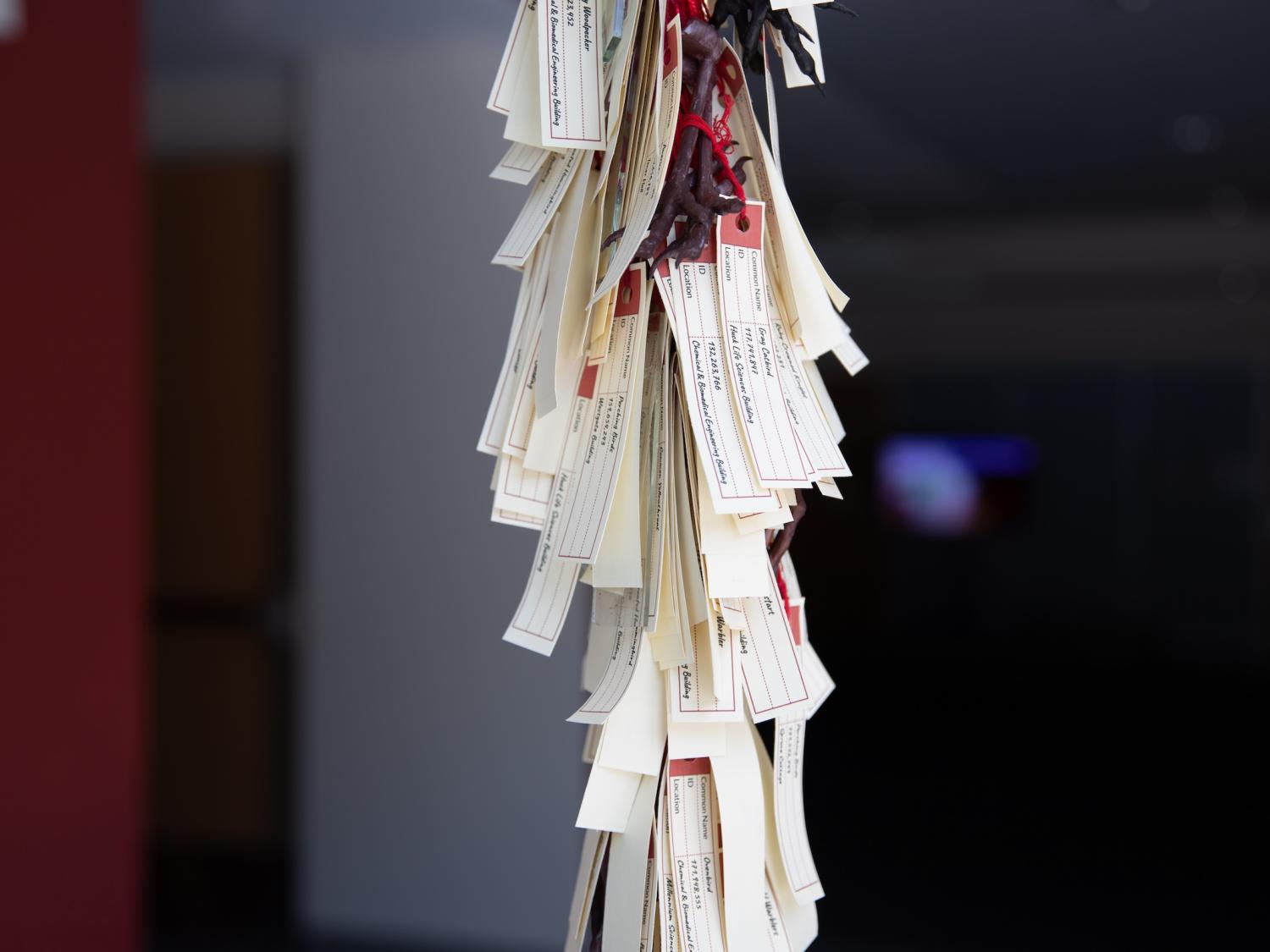 Overlapping slips of paper attached to a pole
