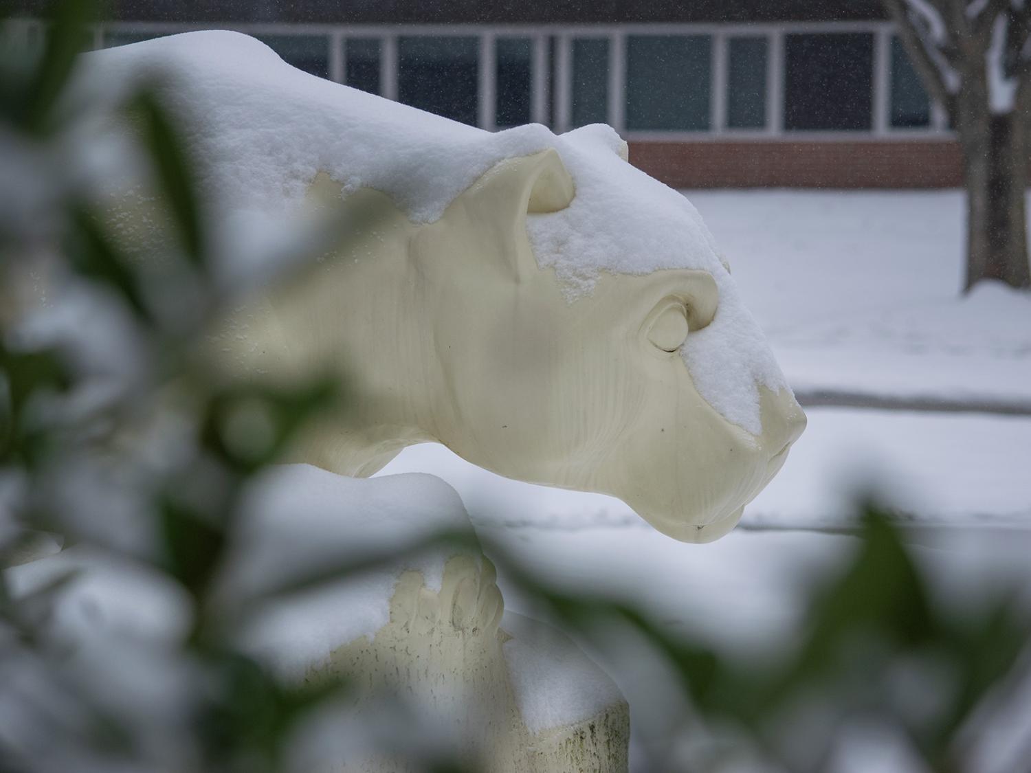 Lion statue covered in snow