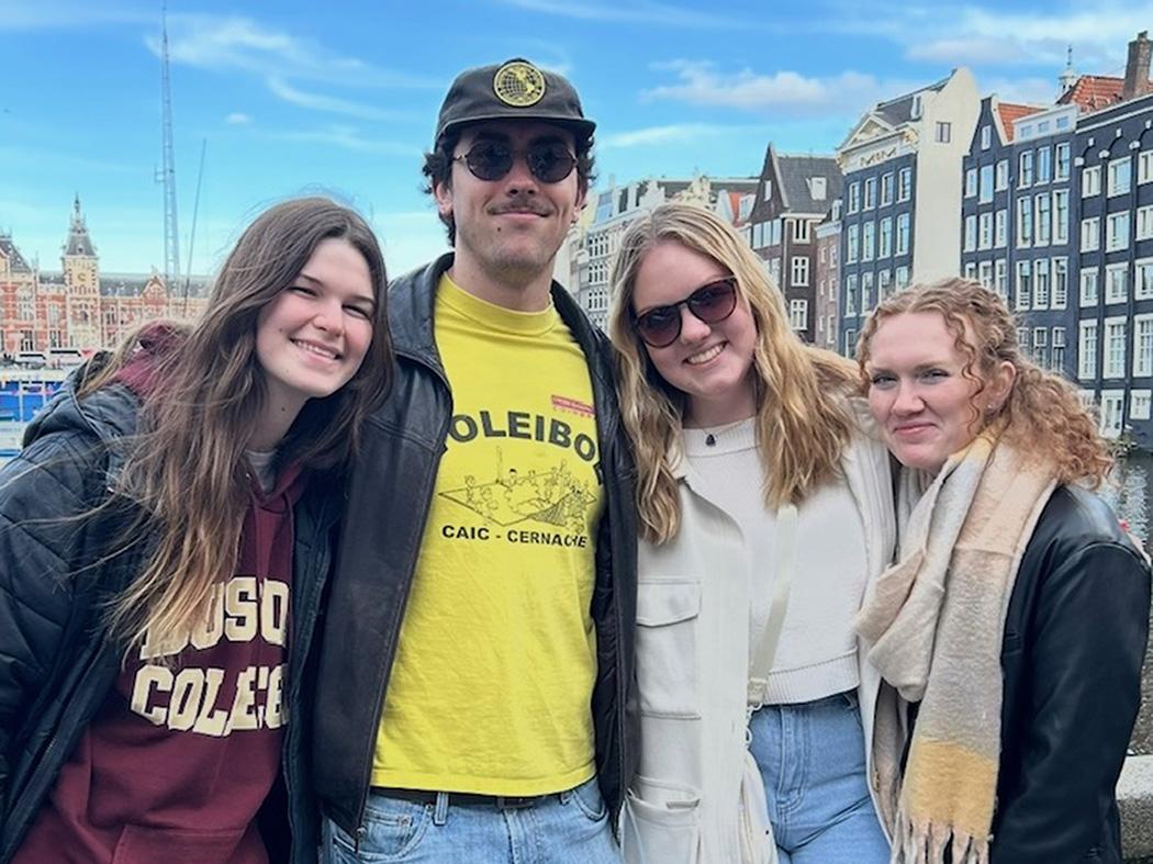 Four students smiling at the camera