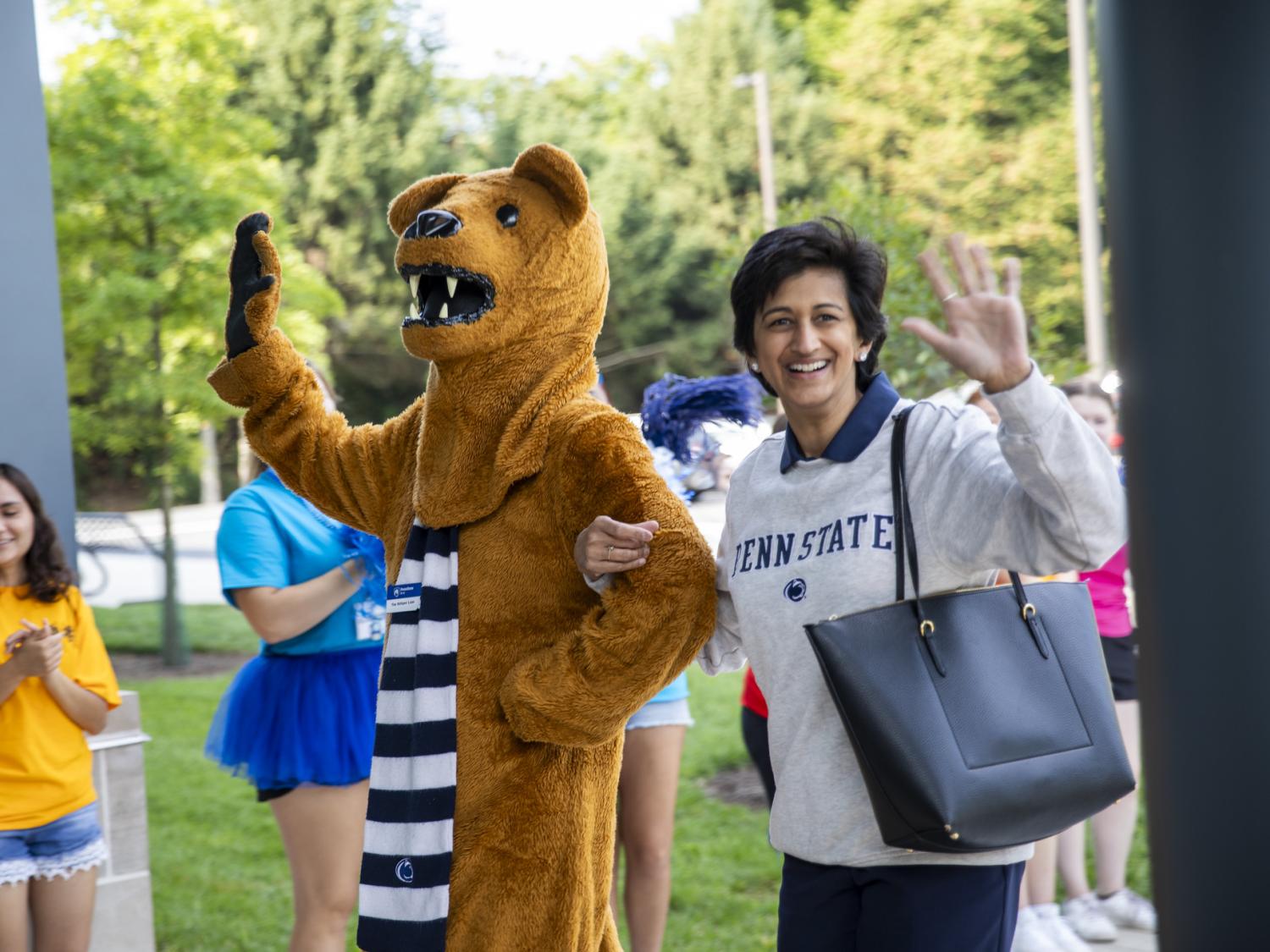 Nittany Lion mascot, left, waves to the crowd with Chancellor Pyati, right