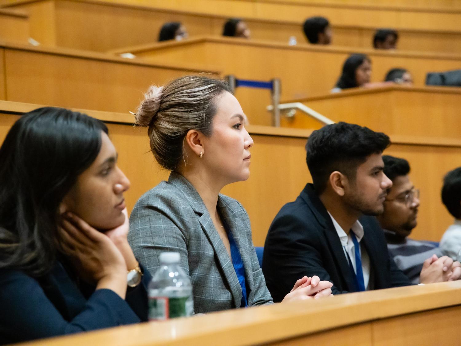 Three students watching a lecture