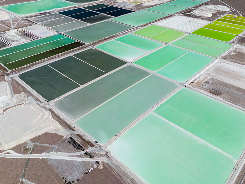 Lithium brine lake showing traditional extraction methods compared to new rock extraction