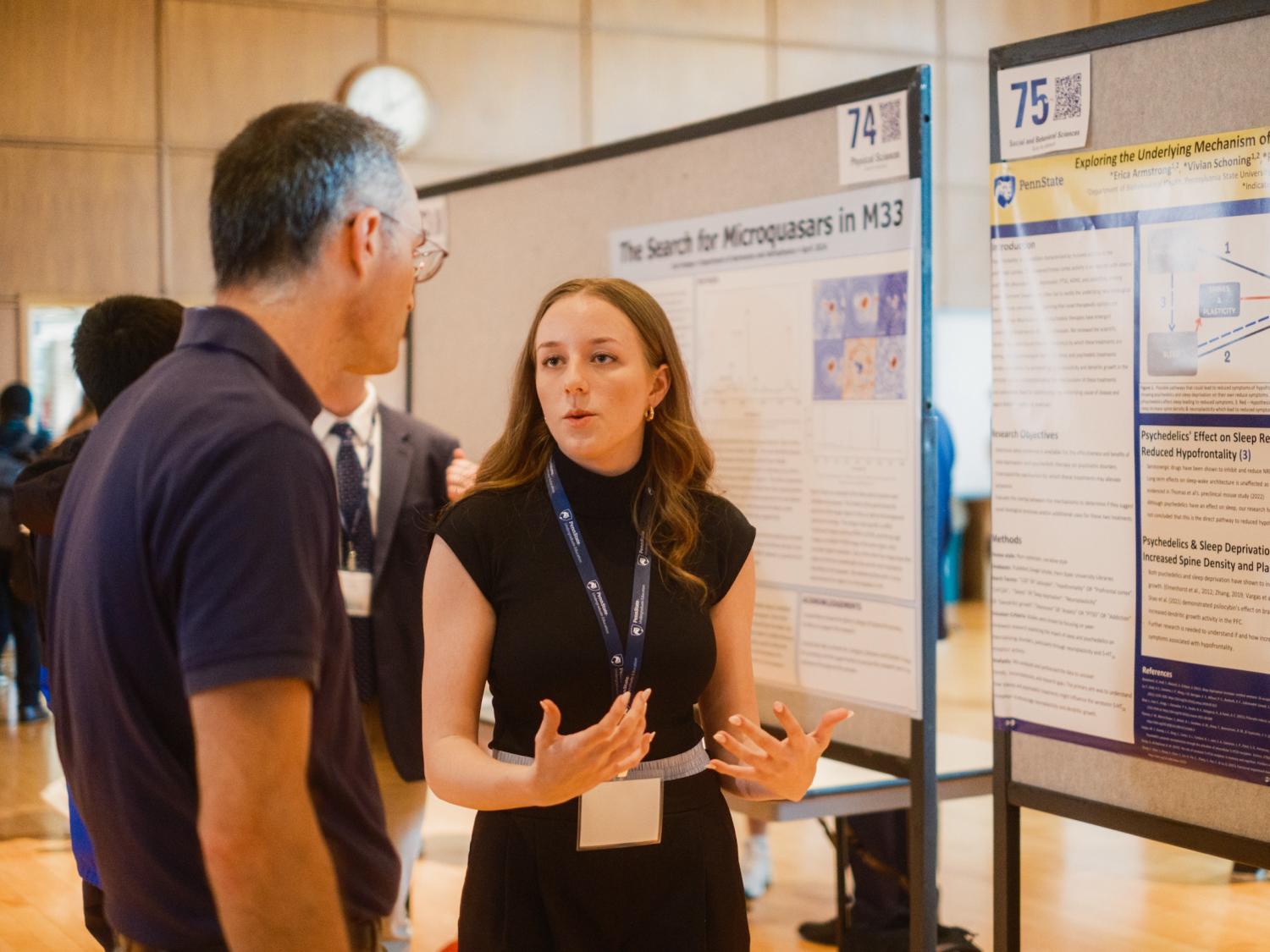 Student presenting research poster to volunteer judge
