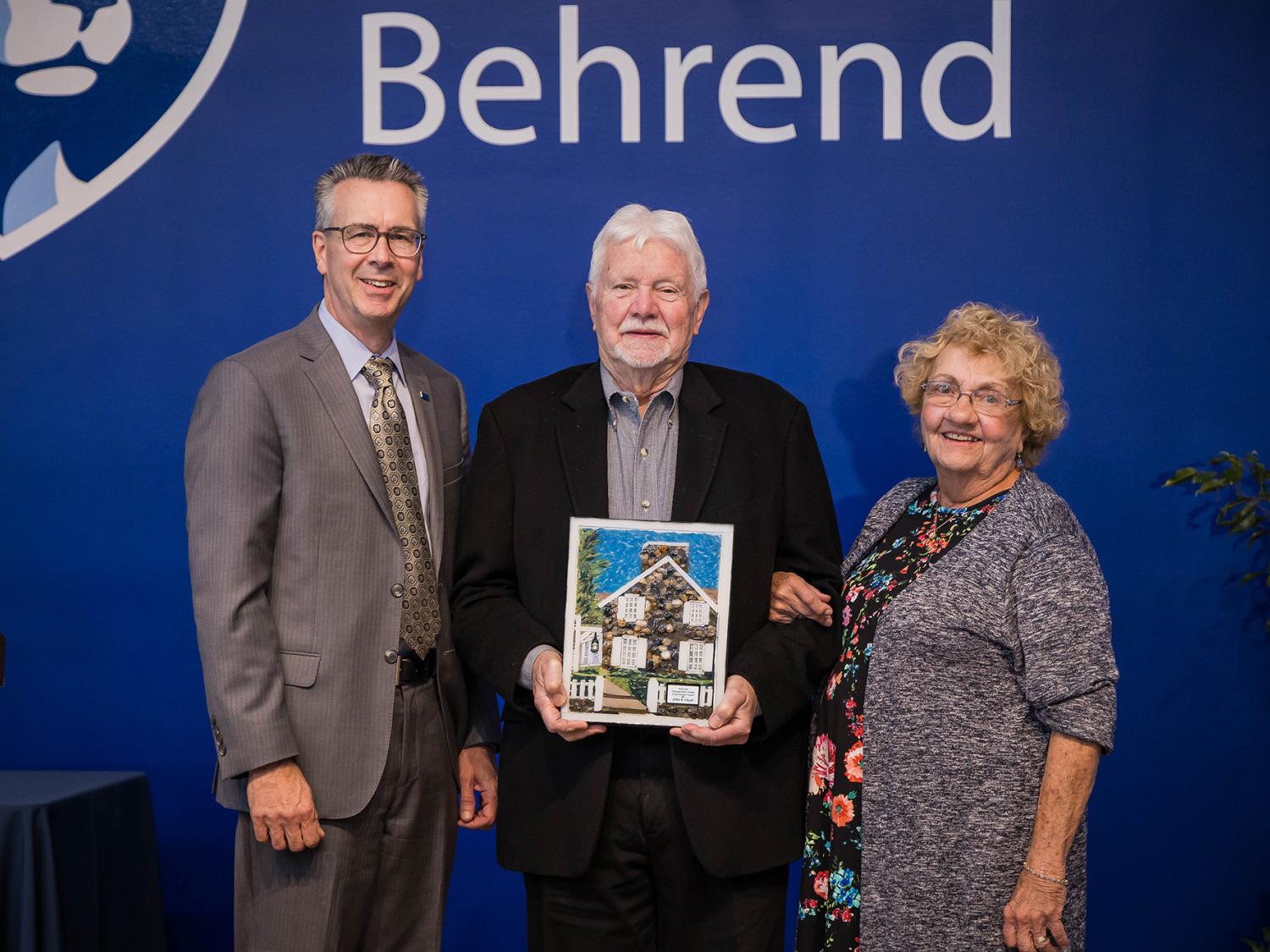 Penn State Behrend Chancellor Ralph Ford presents the Behrend Distinguished Alumni Award to John B. Lloyd and Jean Chambers Lloyd.