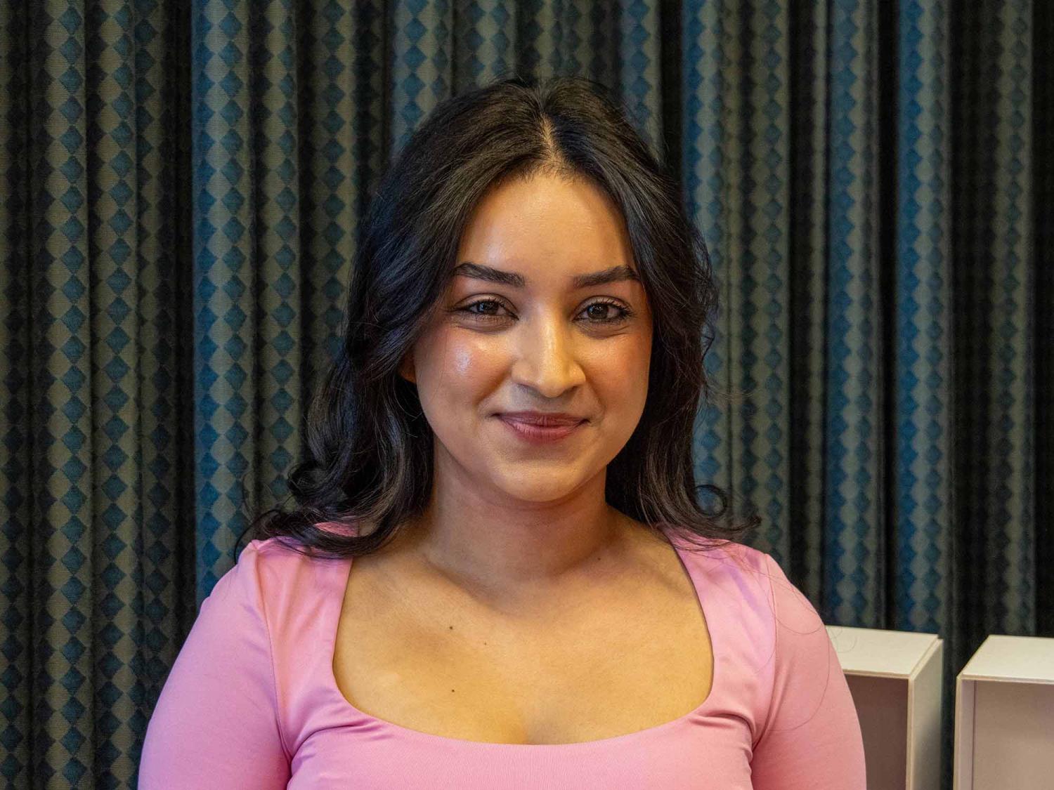 Tapashya Ghimirey smiles on stage at Penn State Greater Allegheny.
