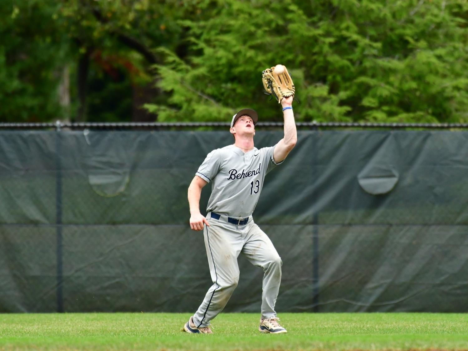 An outfielder catches the ball during a Penn State Behrend baseball game.