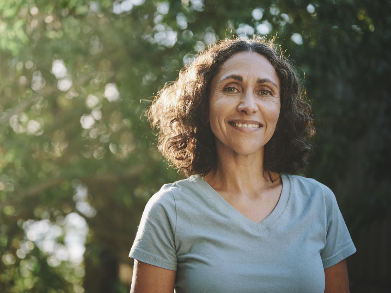 smiling woman outside in park