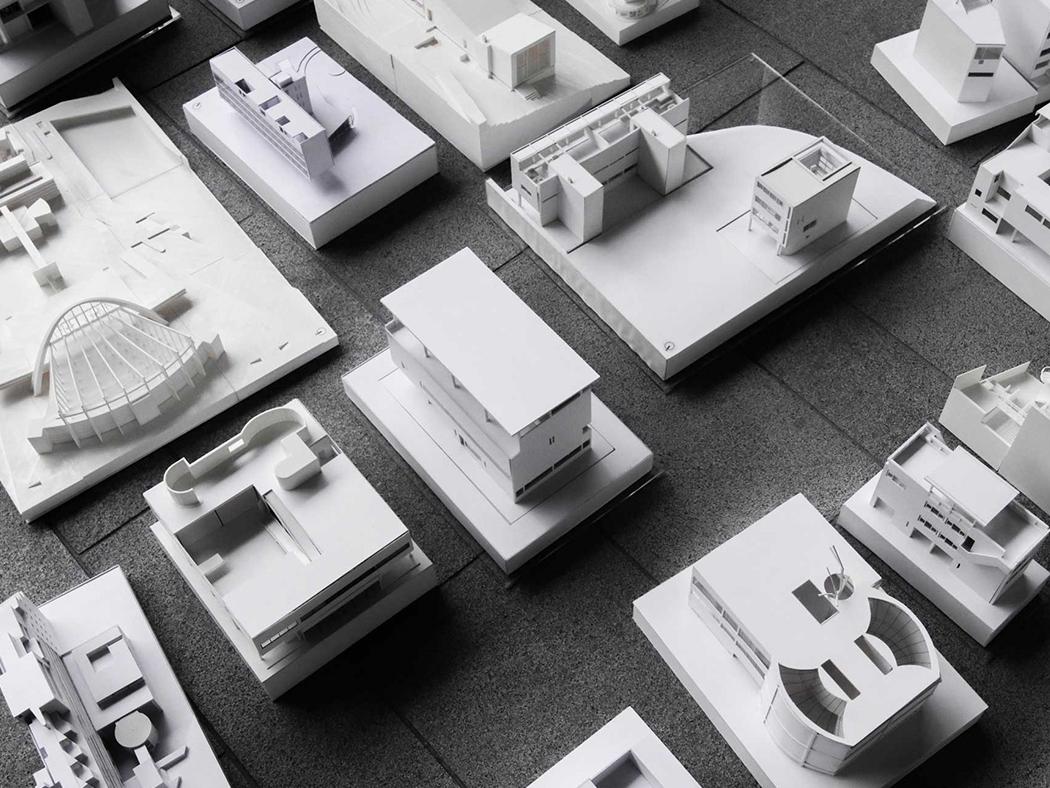 A black and white photograph of several architectural models. 