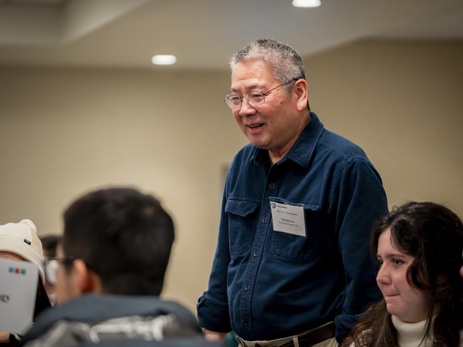 Teh-hui Kao, distinguished professor of biochemistry and molecular biology and chair of the Plant Biology intercollege graduate degree program, speaks with prospective students at a recruiting event on January 19, 2024