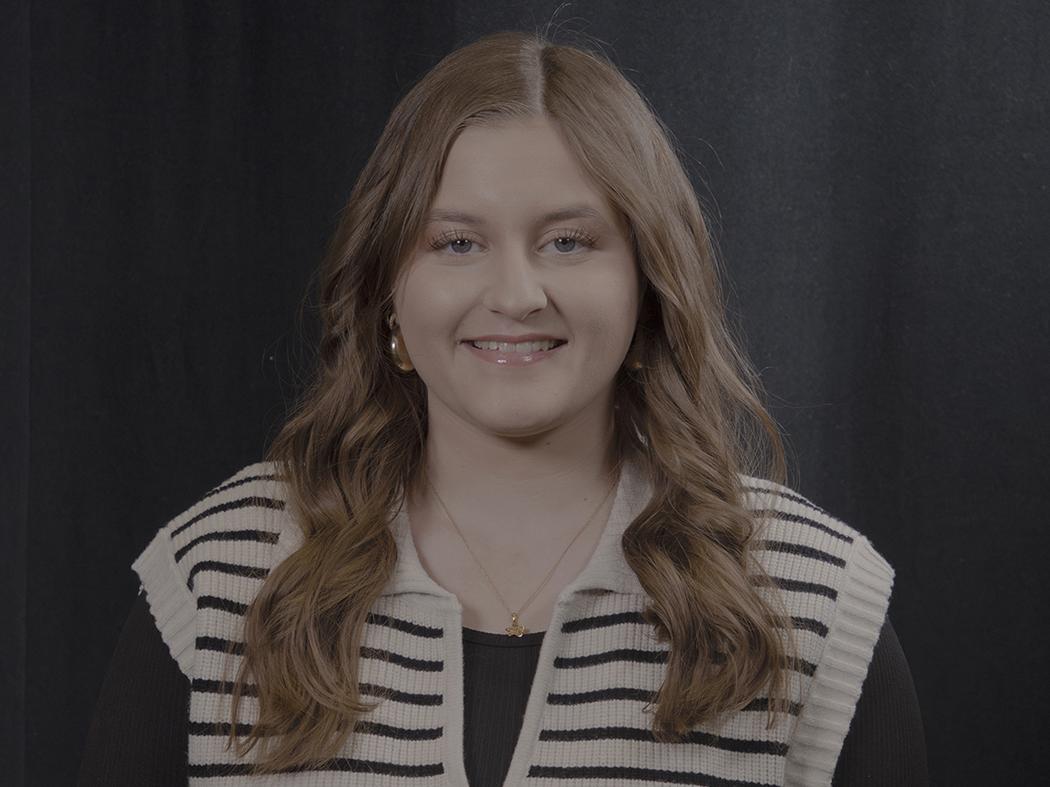 Smiling girl with brown shoulder length hair