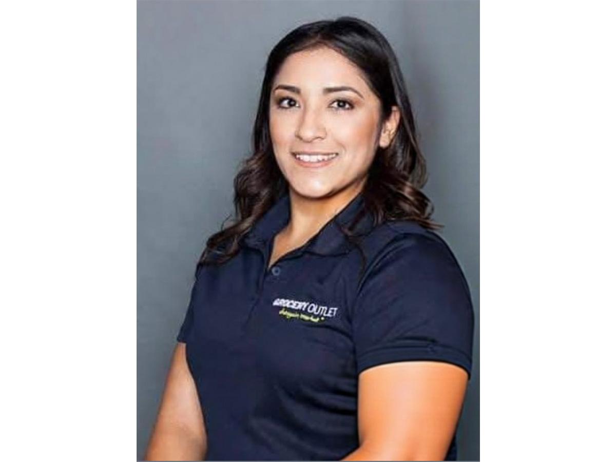 Amanda Paez wearing polo that says Grocery Outlet Bargain Market in top right corner