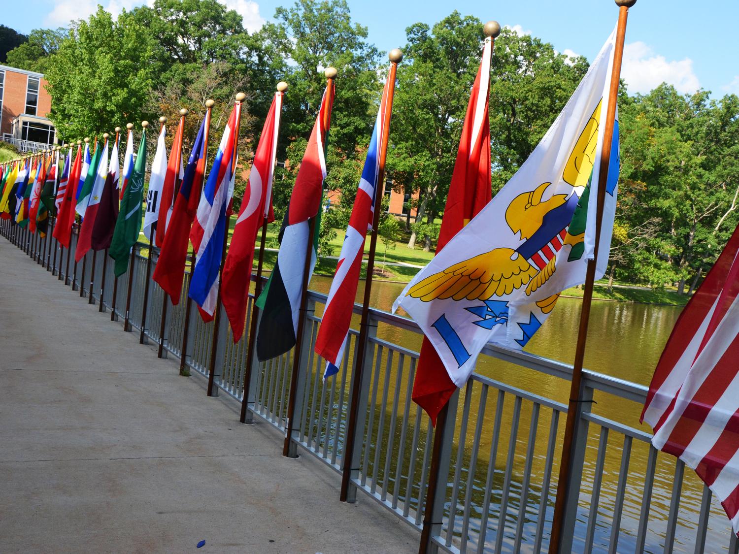 A series of flags mounted on the portico of the Slep Student Center representing all of the countries around the world with students enrolled at Penn State Altoona