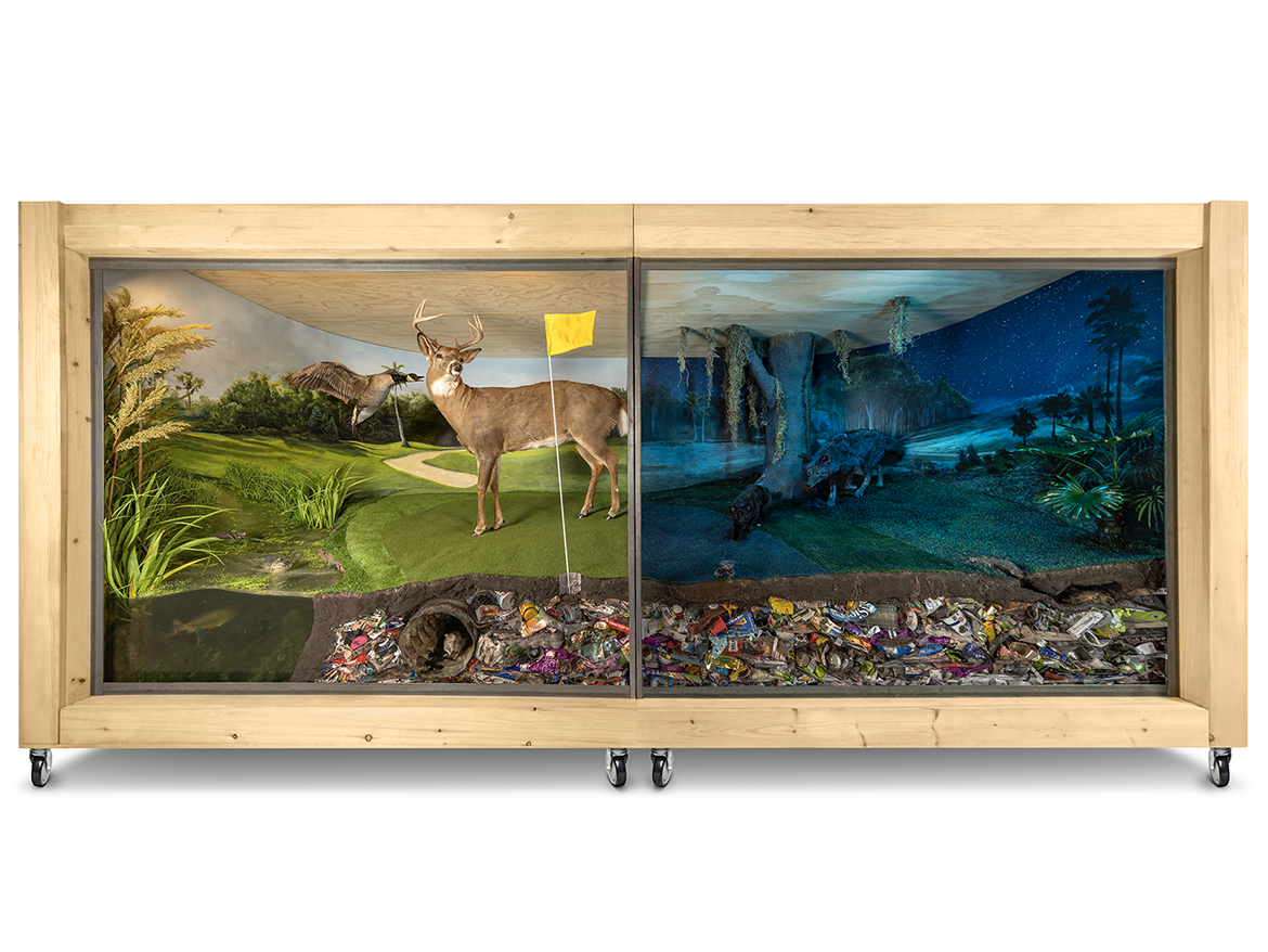 Large sculptural diorama of a golf course in the day at night