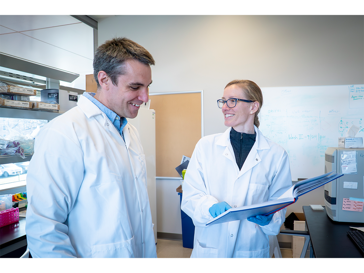 Two people standing in a laboratory