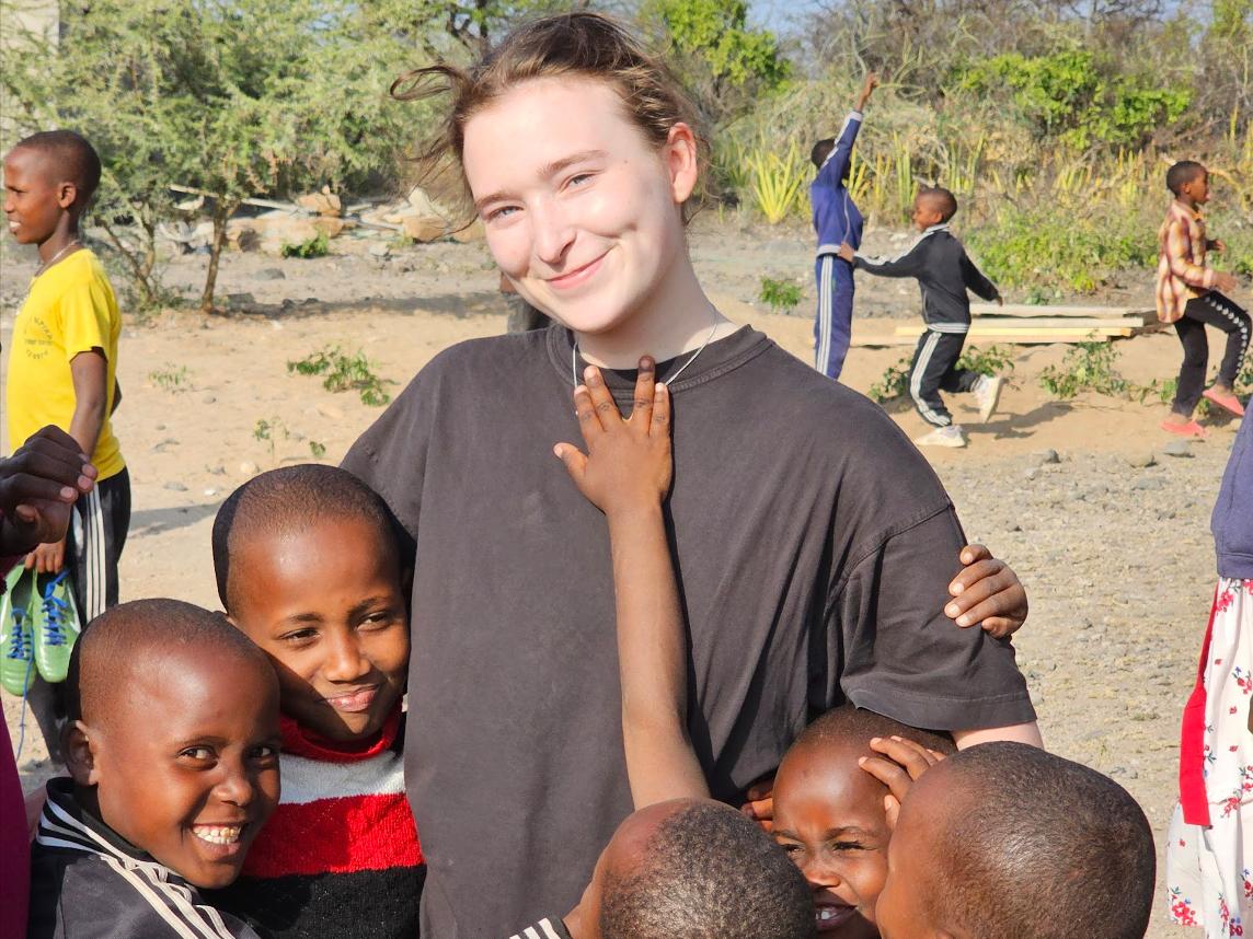 Adelaide surrounded by five Tanzanian children