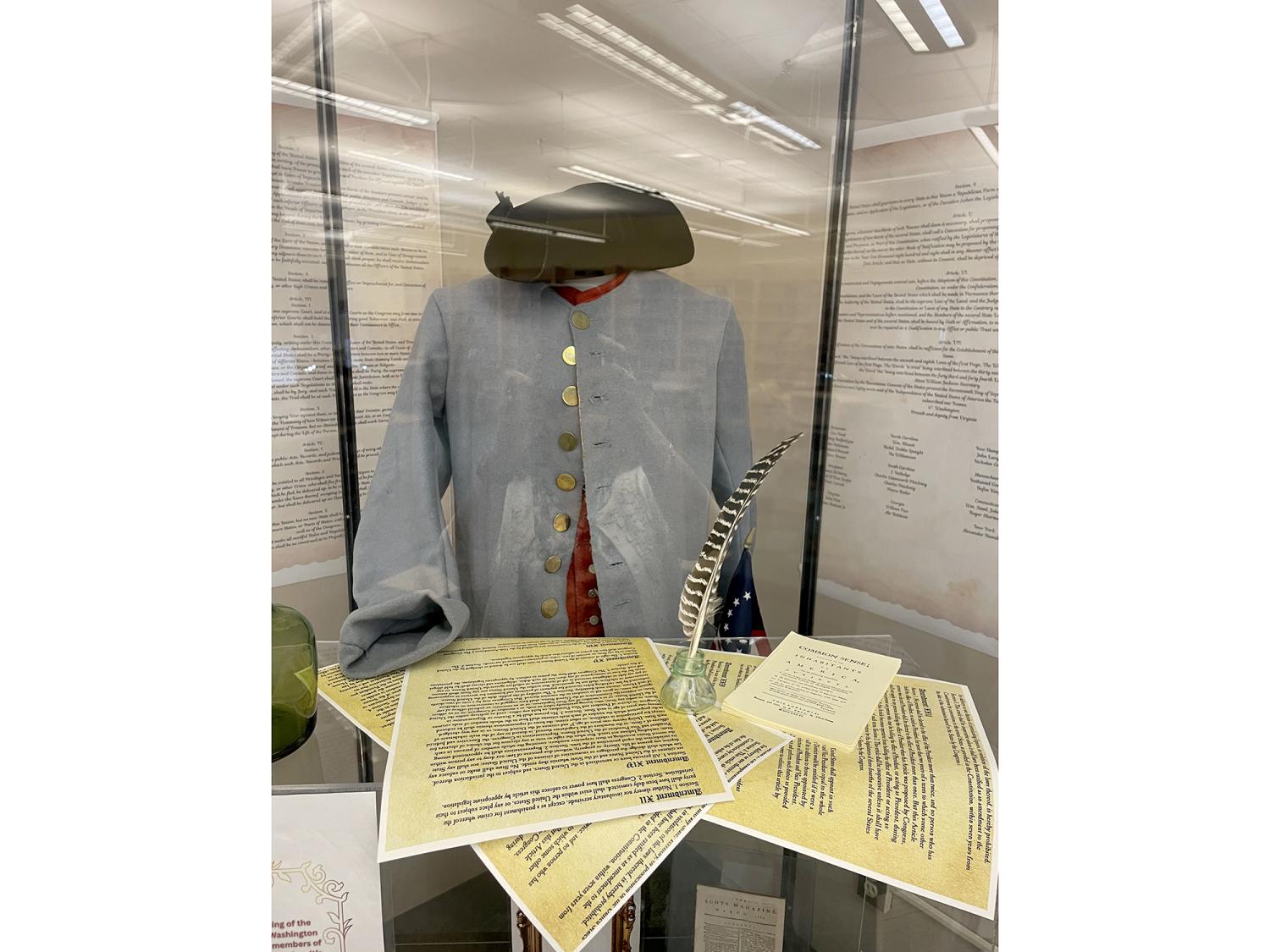 A display showing an historical costume and documents