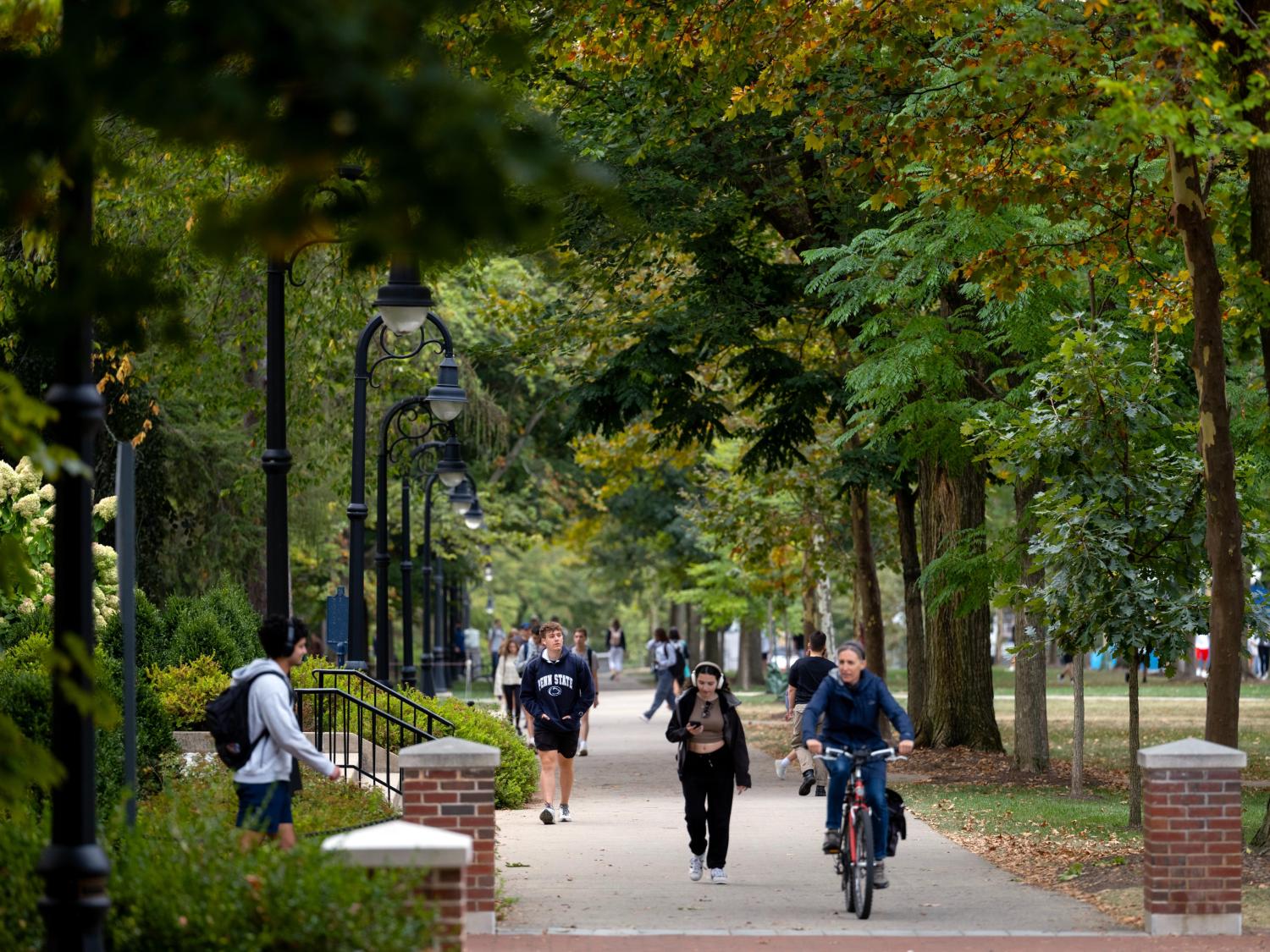 Students walk and bike on Penn State's University Park campus