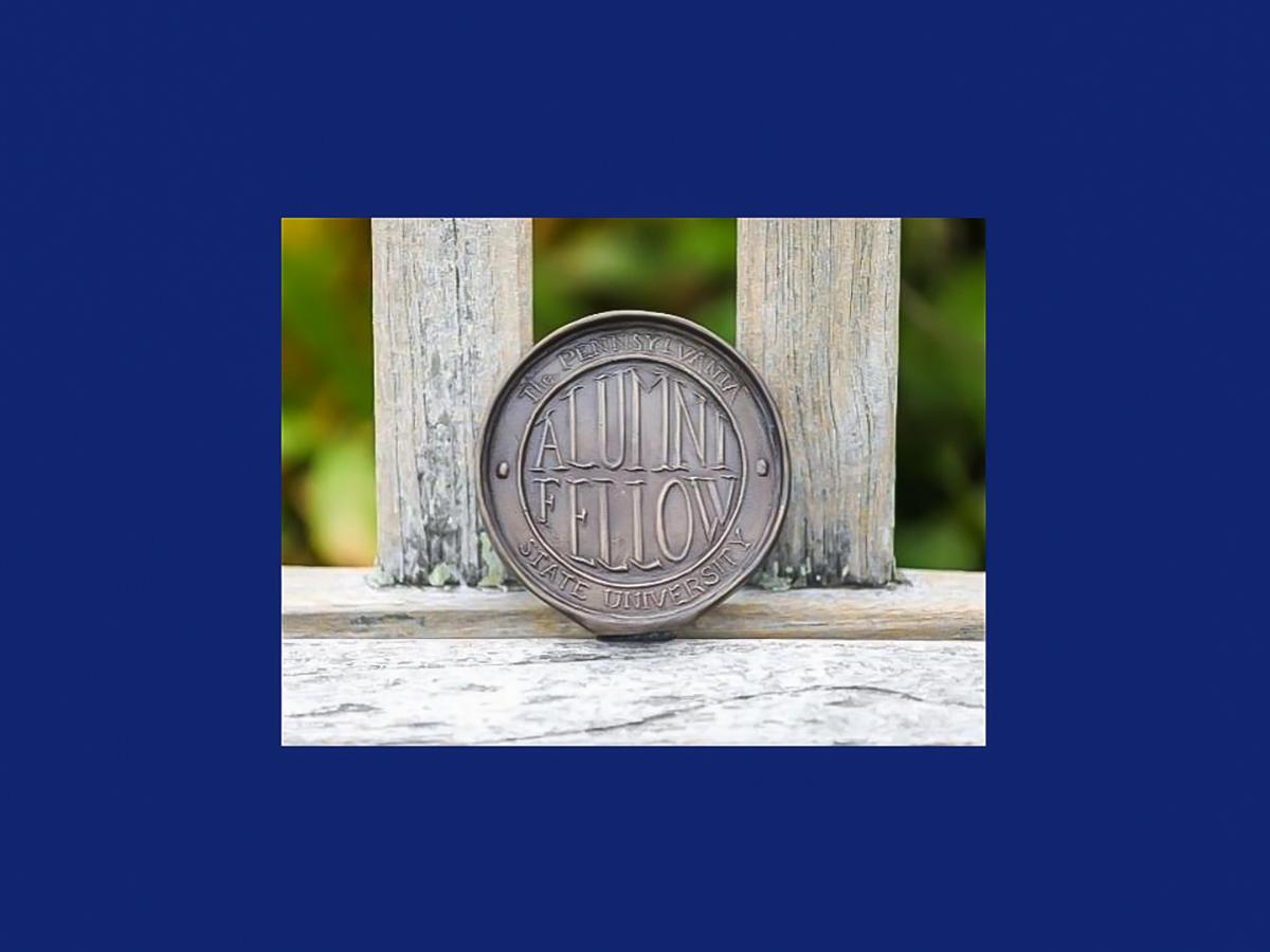 The Alumni Fellow Award, a round, metal medallion 