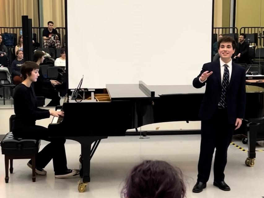 Dominic DiFrancesco sings next to a piano