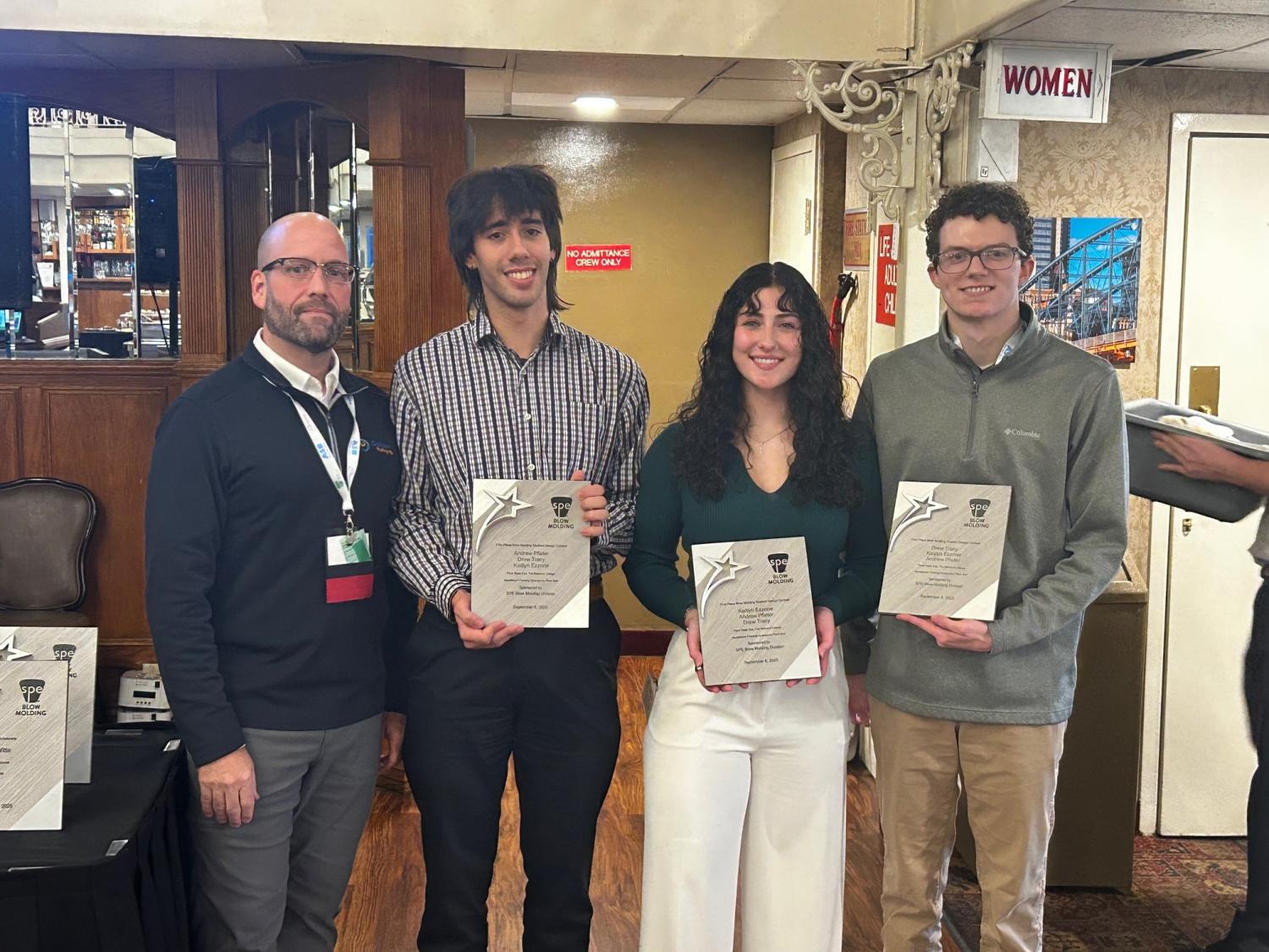 A student team from Penn State Behrend poses with certificates after winning an SPE design competition.