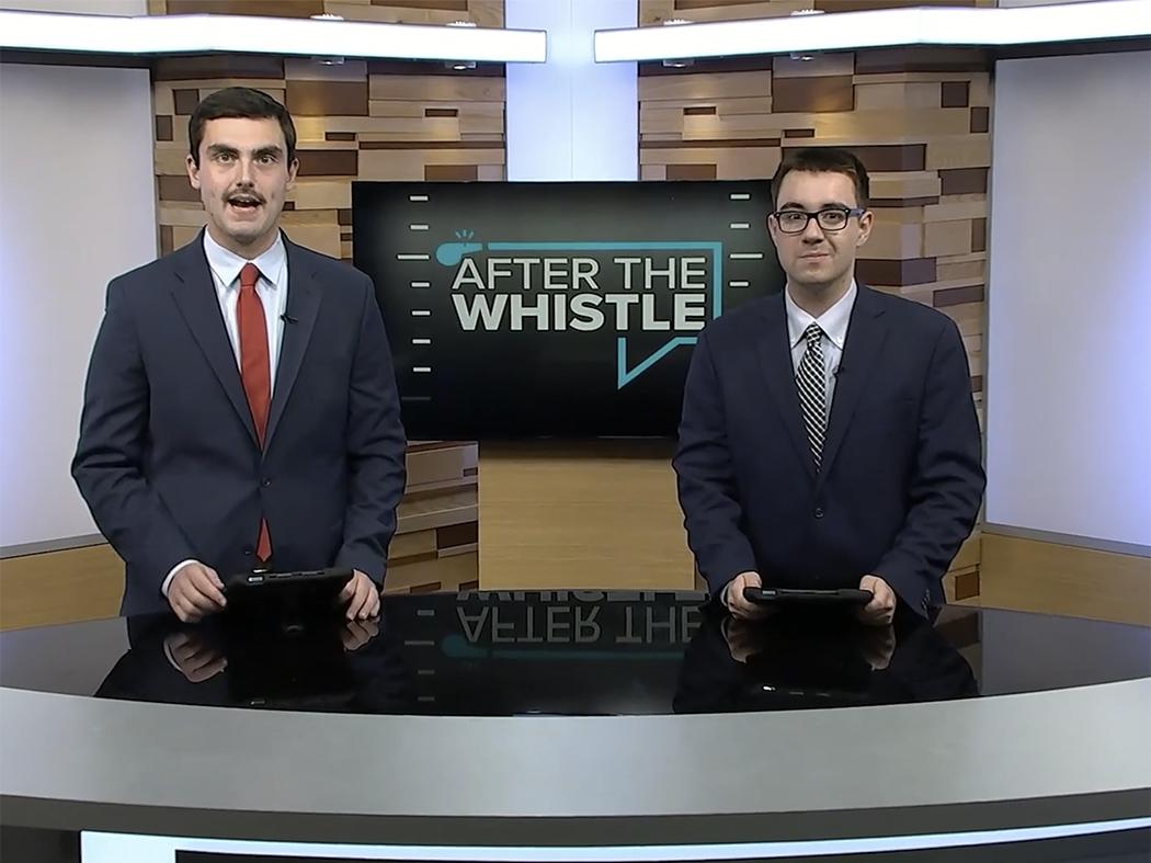 Two coat-and-tie students on a TV studio set