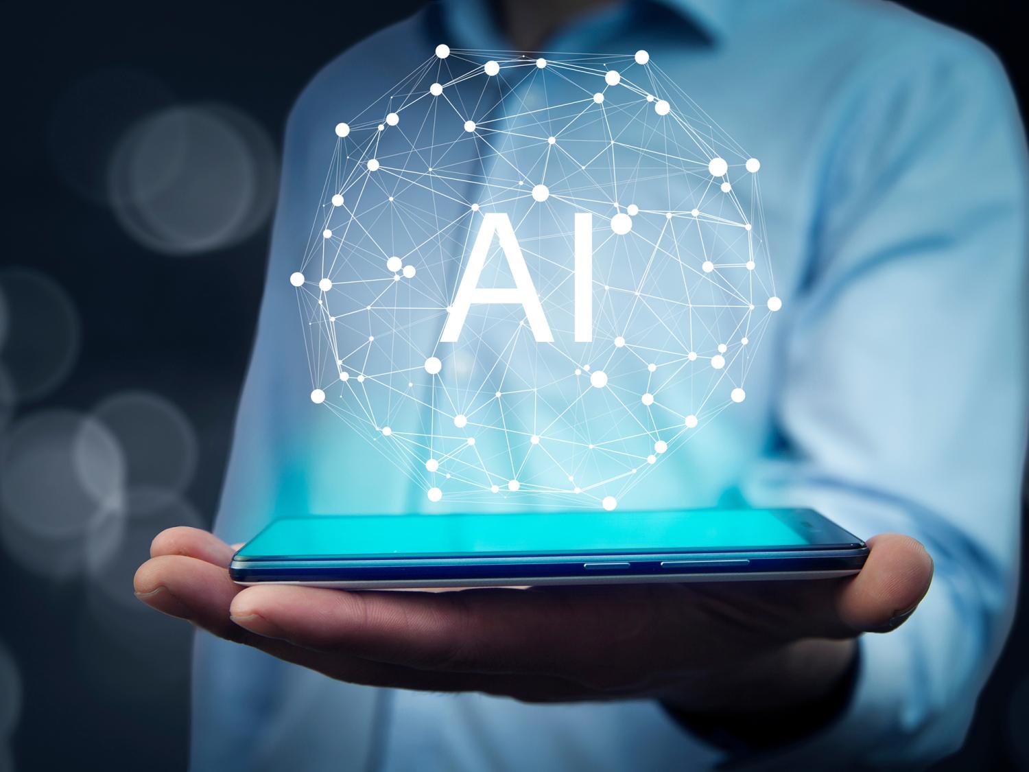 A person holds a smartphone with a glowing digital sphere labeled AI, symbolizing artificial intelligence technology.