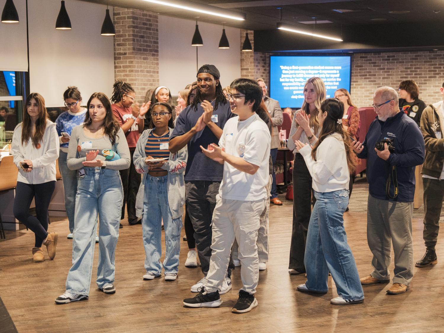 Group of students clapping during presentation
