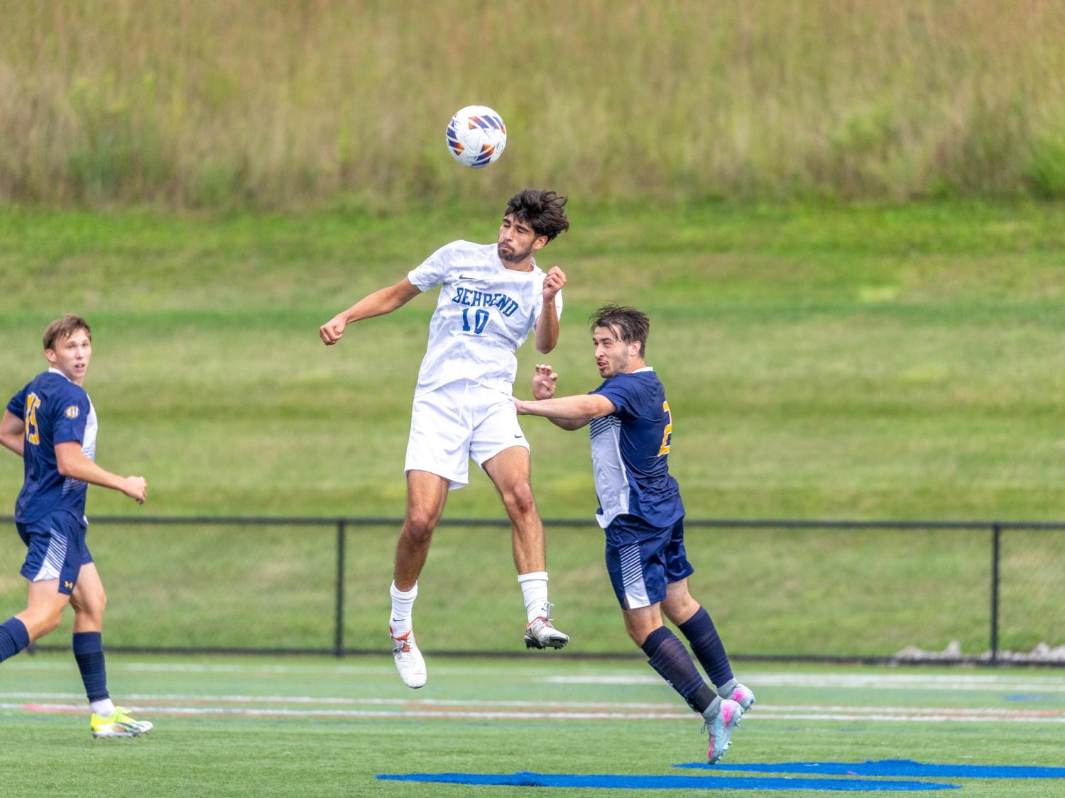 Penn State Behrend soccer player Owen Petersen heads the ball.
