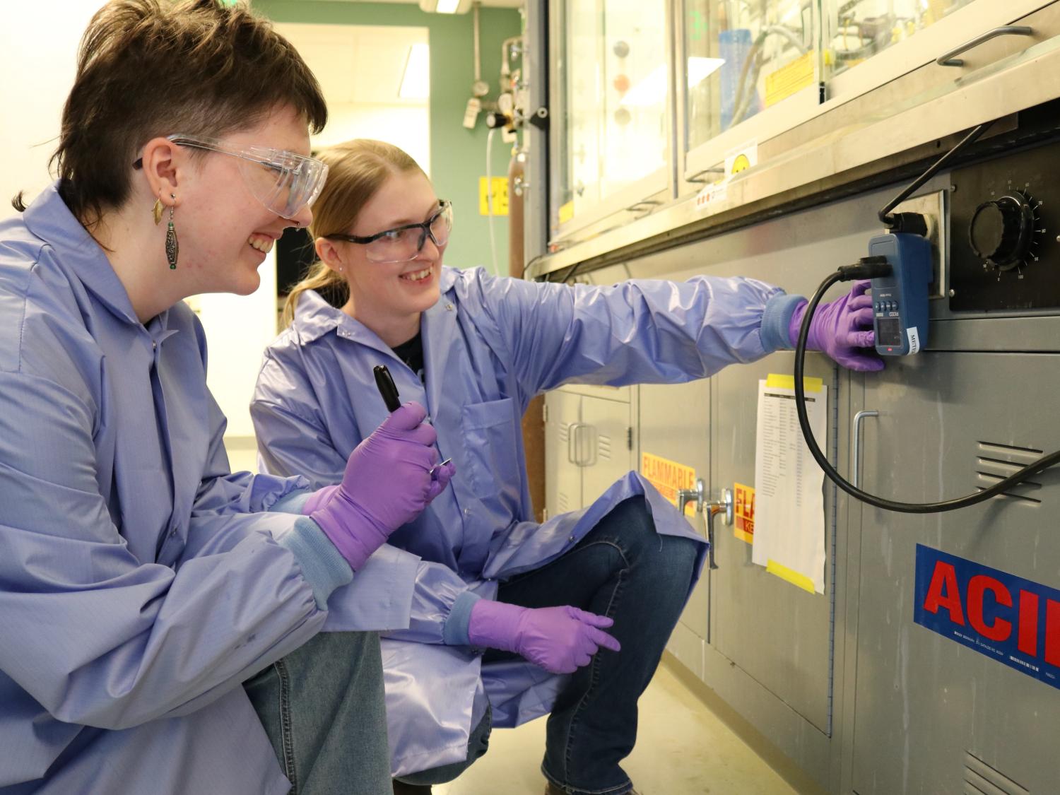 Two people looking at an outlet in a lab