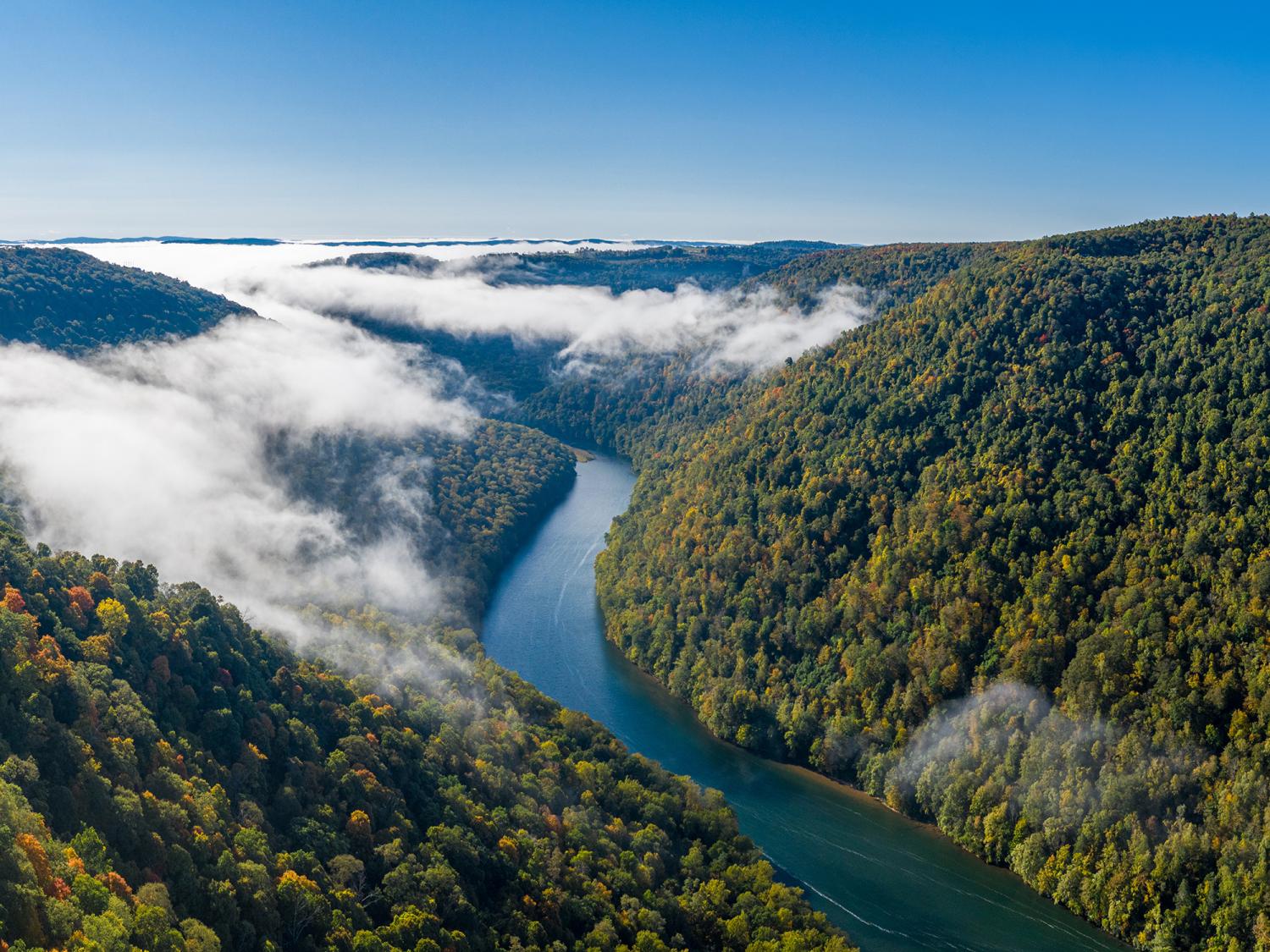 Aerial drone image of the Cheat River flowing through narrow wooded gorge in the autumn towards Cheat Lake near Morgantown, WV