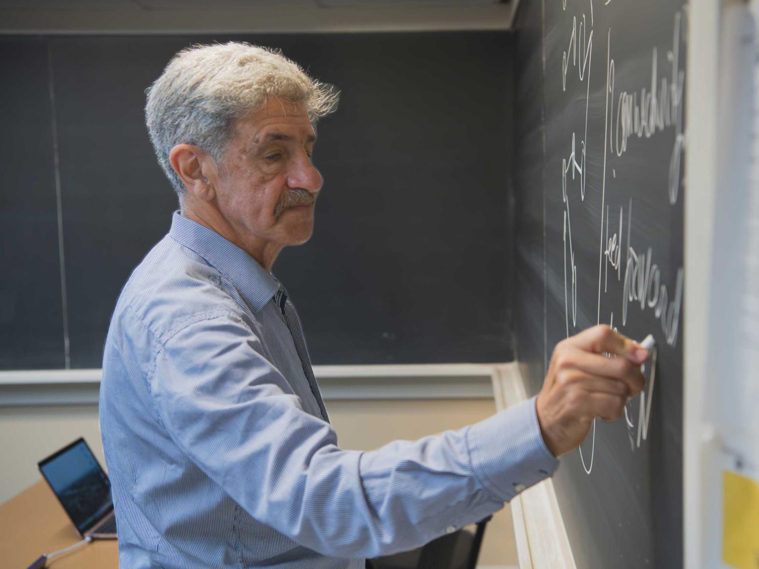 Leonid Berlyand writes on a chalkboard