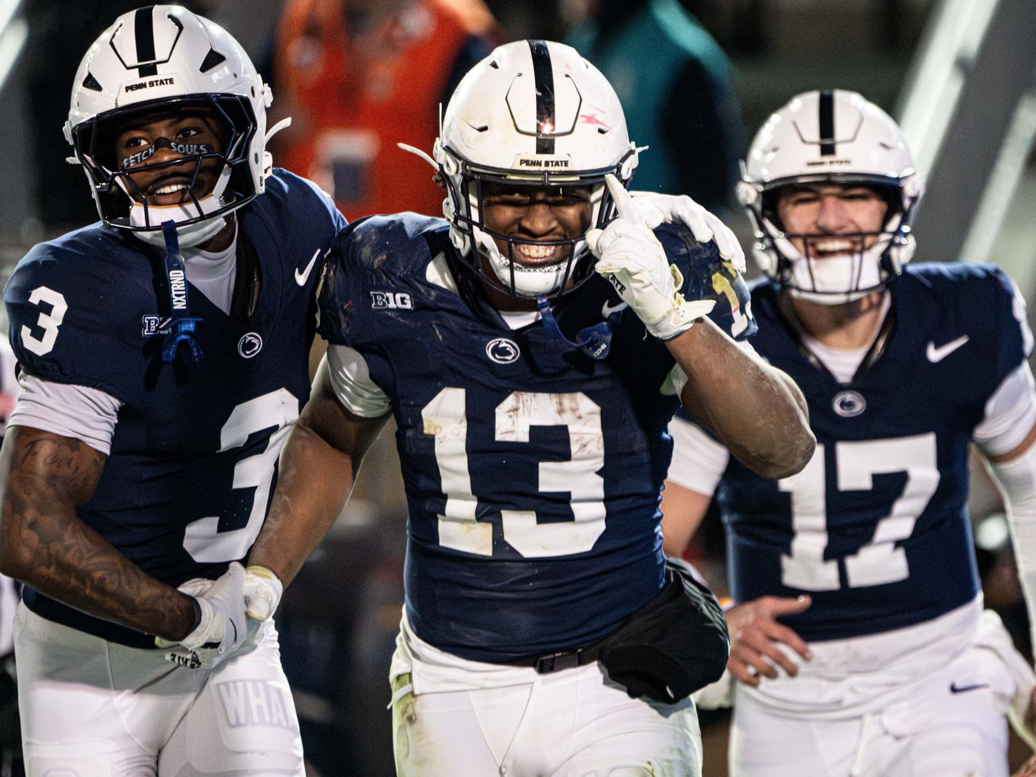 Football players smile and celebrate together 