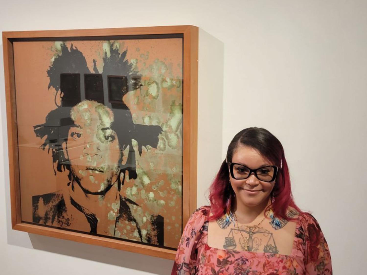 Person standing in front of artwork