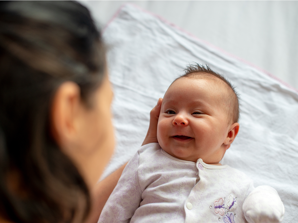 Infant smiling at mother