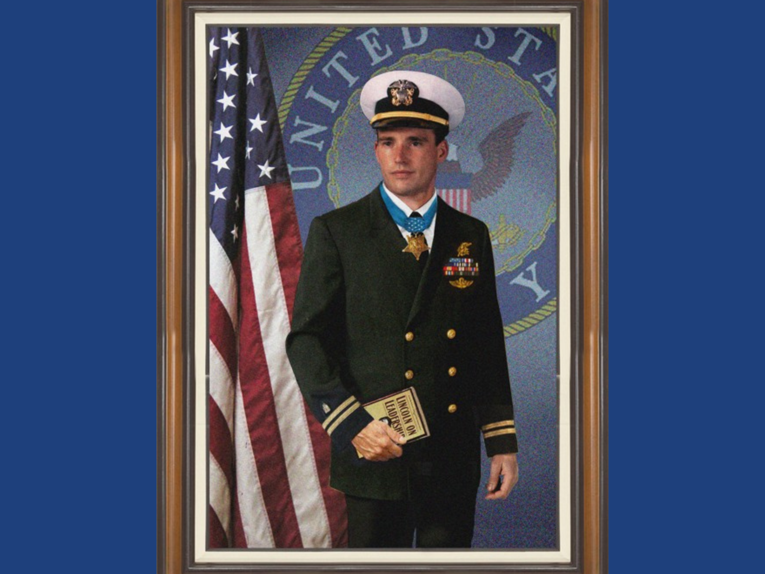 Blue background, portrait of a man wearing a dress Navy uniform in front of an American Flag.