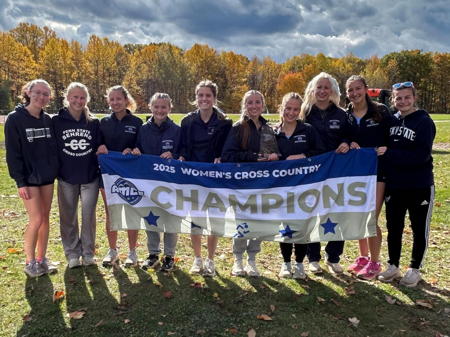 The Penn State Behrend women's cross country team poses with the AMCC championship banner.
