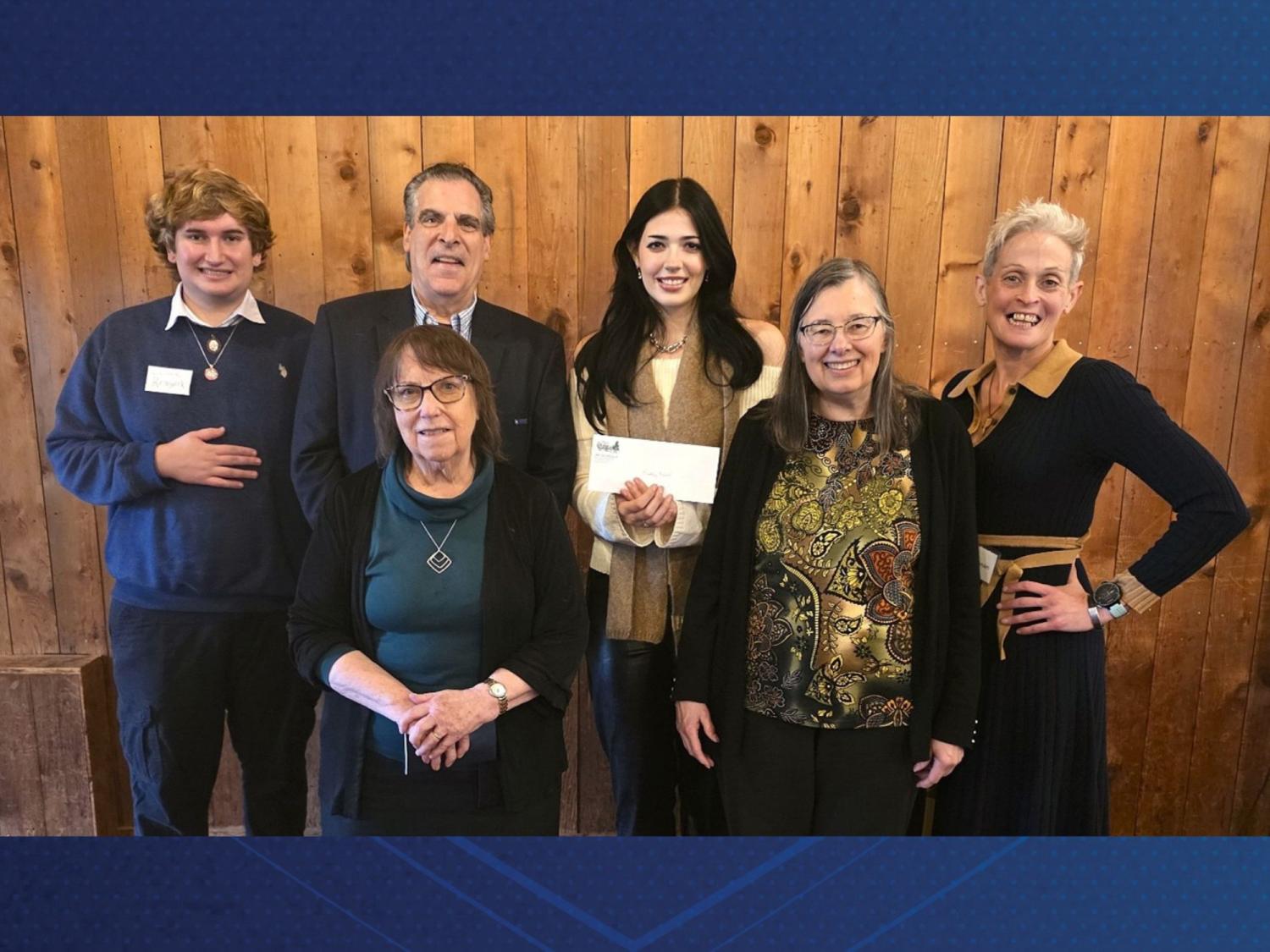 A group of Arts at Hayfield organization members pose with the recipient of Arts at Hayfield's 2025 award