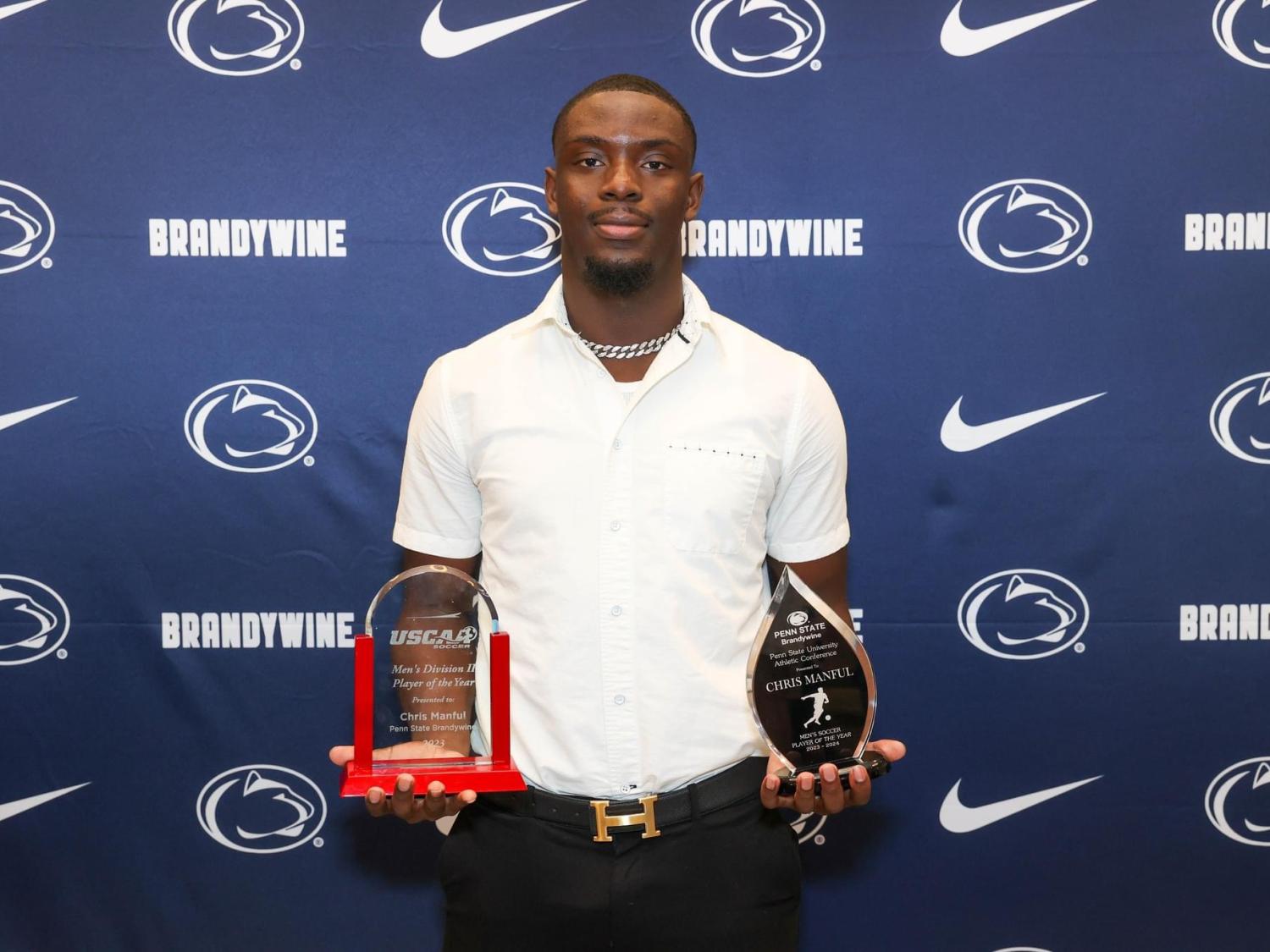 Chris Manful holding trophies from Brandywine Athletics Banquet